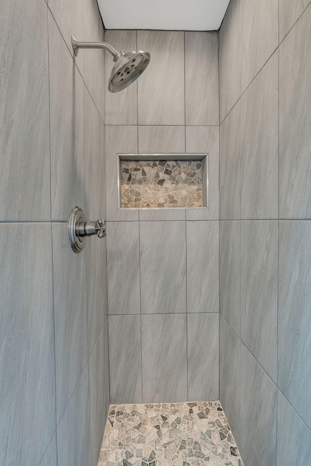 bathroom with tiled shower