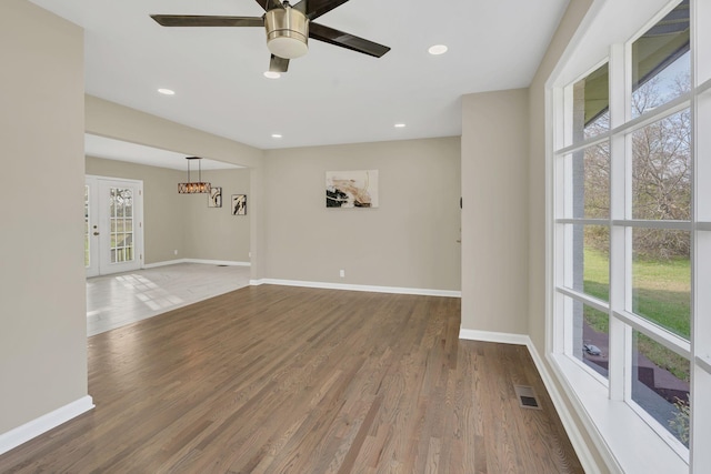 spare room featuring wood-type flooring and ceiling fan