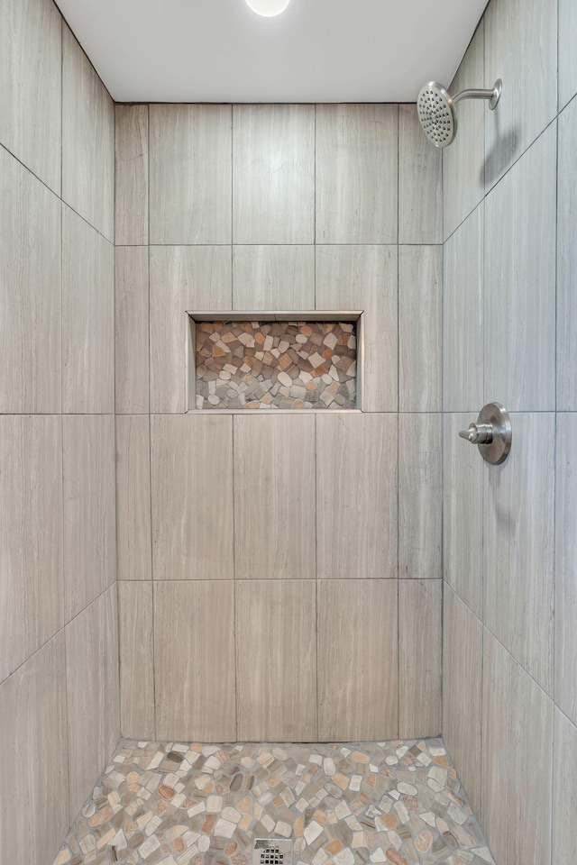 bathroom with tiled shower