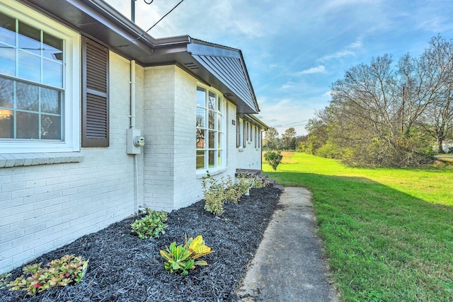 view of property exterior with a lawn