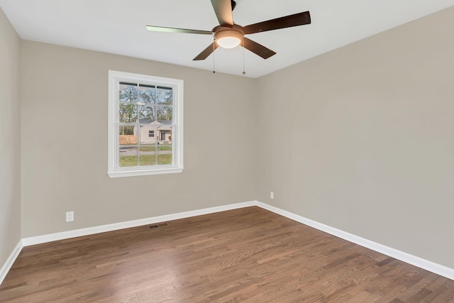 spare room with hardwood / wood-style floors and ceiling fan