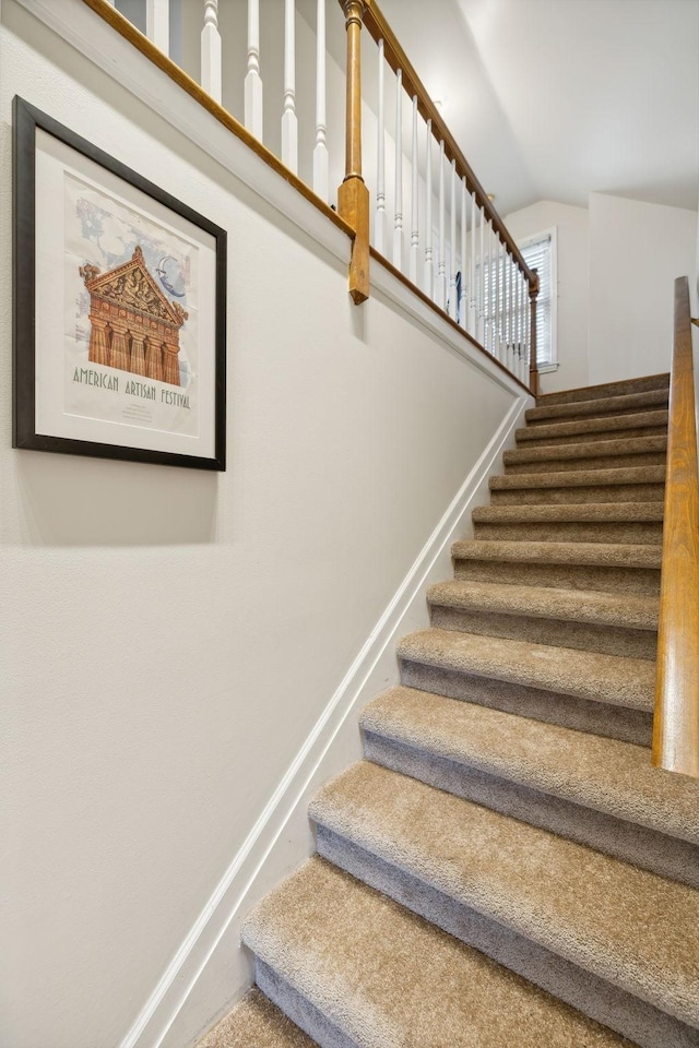 stairs with vaulted ceiling