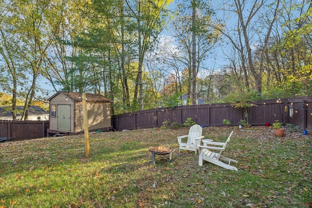 view of yard with an outdoor fire pit and a shed