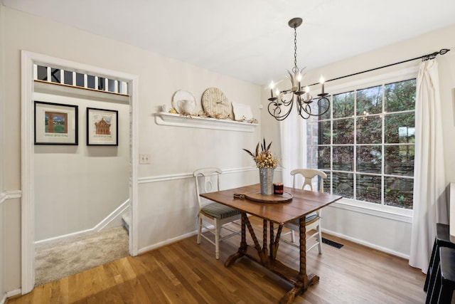 dining room featuring hardwood / wood-style flooring and a notable chandelier