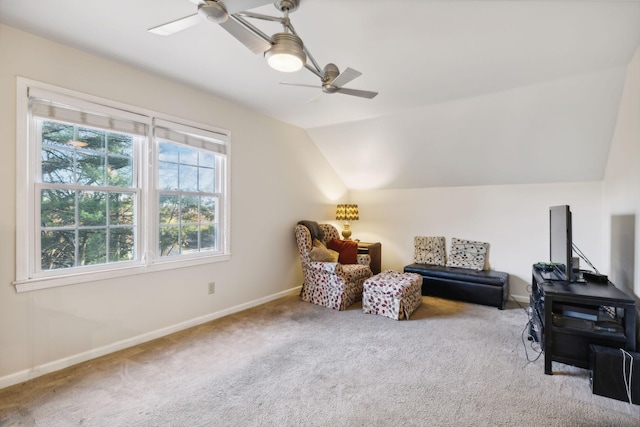 living area with ceiling fan, lofted ceiling, and carpet floors