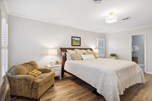 bedroom featuring crown molding, connected bathroom, and light hardwood / wood-style flooring