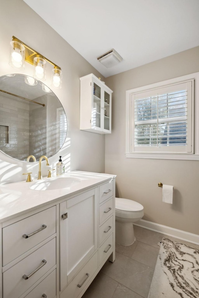 bathroom with vanity, tile patterned floors, and toilet