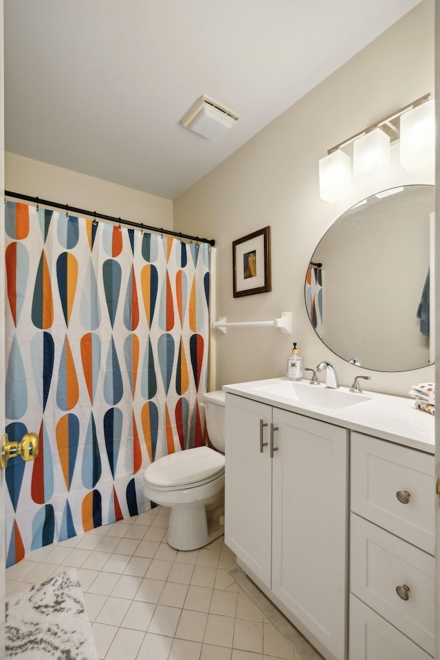 bathroom featuring vanity, toilet, and tile patterned flooring