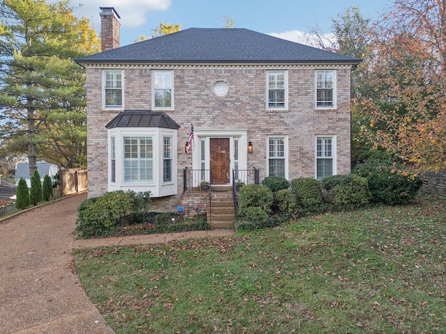 colonial-style house with a front yard