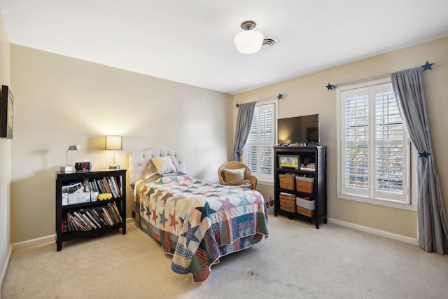 bedroom featuring light carpet