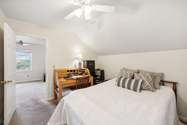 carpeted bedroom with vaulted ceiling and ceiling fan