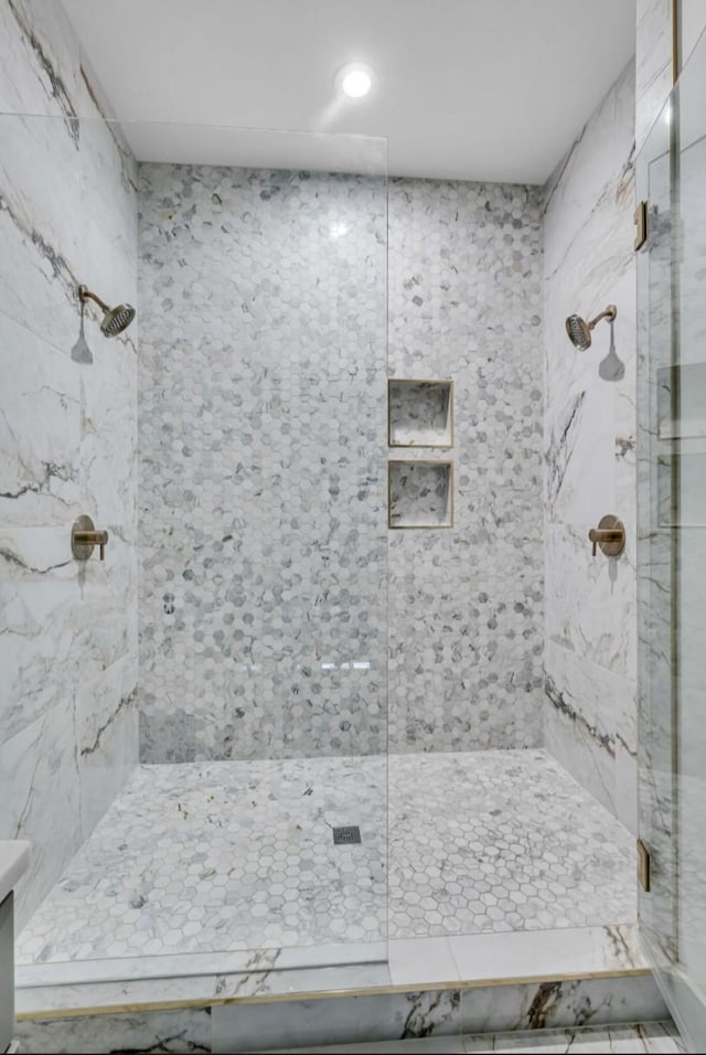 bathroom with a tile shower