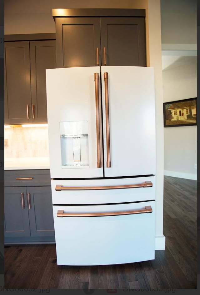 details featuring gray cabinetry, dark wood-type flooring, and high end white refrigerator