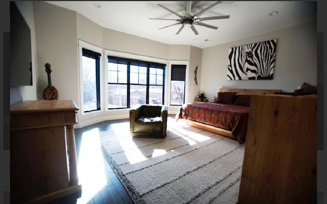 bedroom with wood-type flooring and ceiling fan