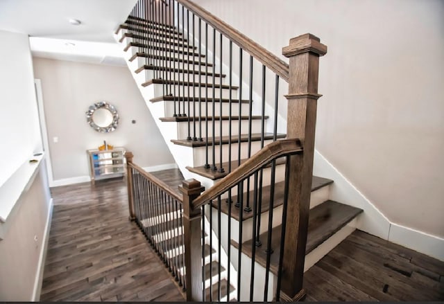 stairs featuring hardwood / wood-style floors