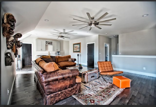 living room featuring dark hardwood / wood-style floors and ceiling fan