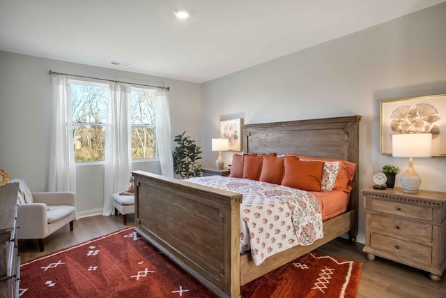 bedroom with dark hardwood / wood-style flooring