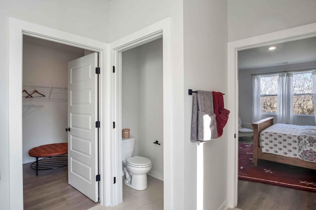 bathroom featuring hardwood / wood-style flooring and toilet