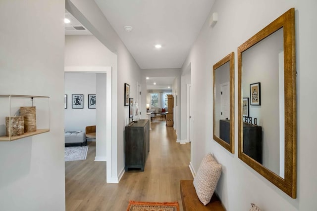 corridor with light hardwood / wood-style floors