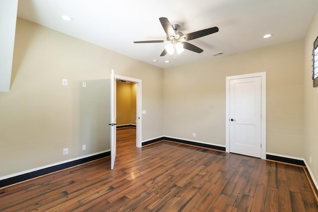 unfurnished room with dark hardwood / wood-style flooring and ceiling fan