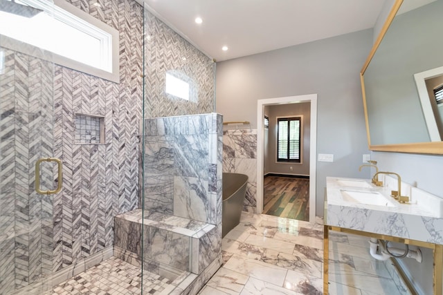 bathroom with vanity, tile walls, and a shower with shower door