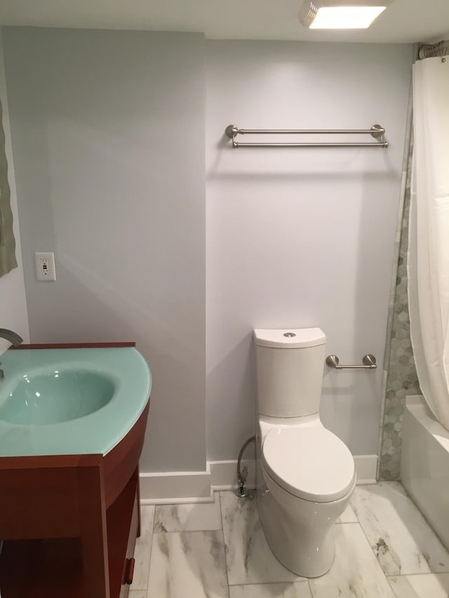 bathroom with shower / tub combo and toilet