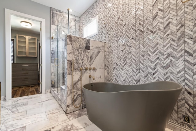 bathroom featuring shower with separate bathtub and tile walls