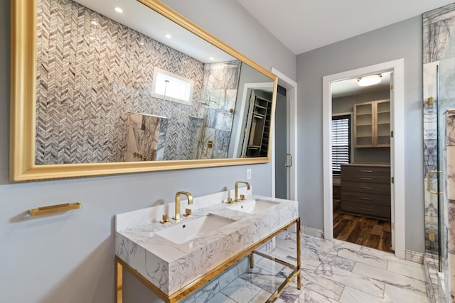 bathroom featuring sink and a tile shower