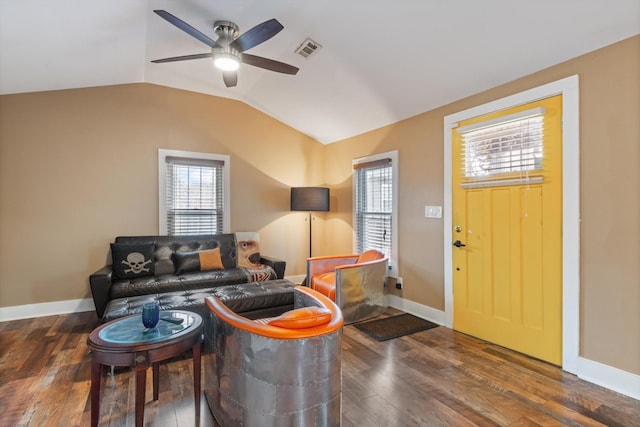 living room featuring ceiling fan, lofted ceiling, a wealth of natural light, and dark hardwood / wood-style flooring