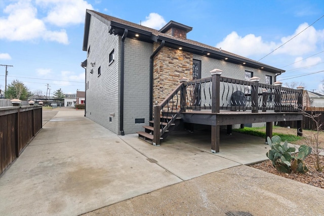 rear view of property featuring a wooden deck