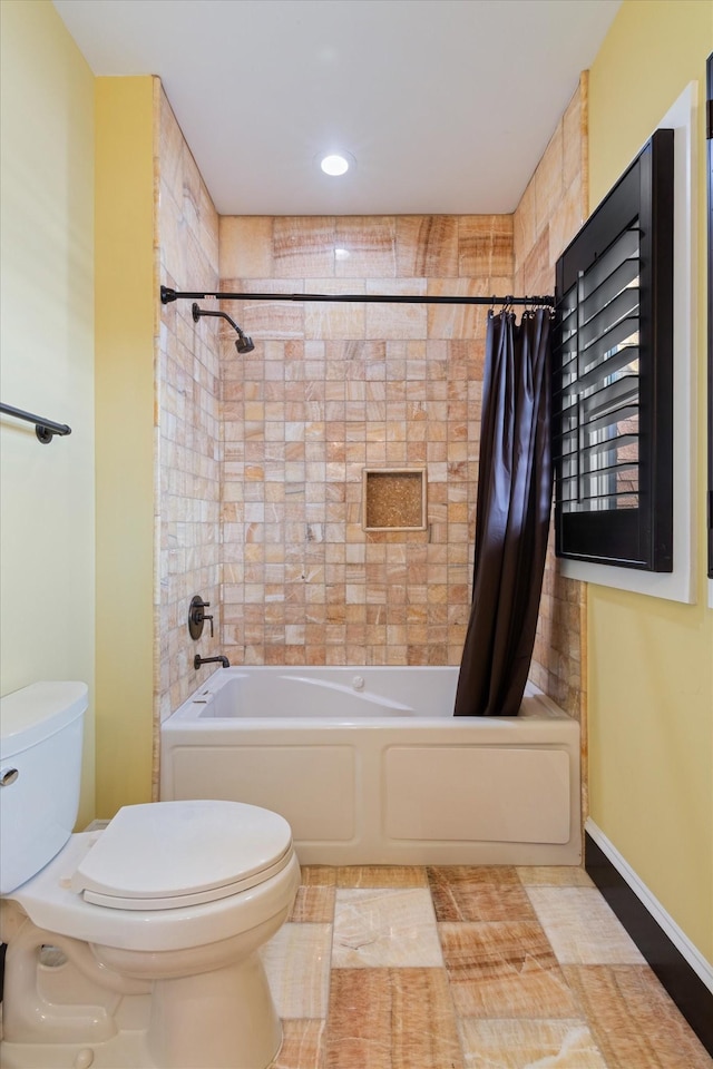 bathroom with shower / bath combo and toilet