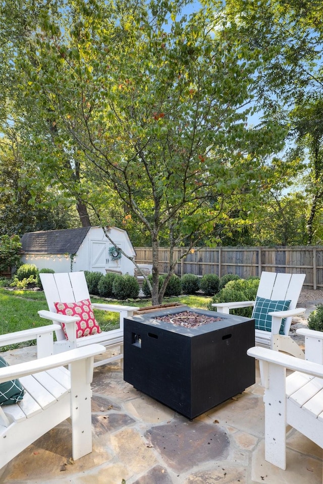 view of patio / terrace with a storage shed and an outdoor fire pit