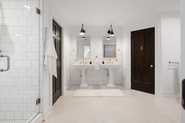 bathroom with an enclosed shower, tile patterned flooring, and tile walls