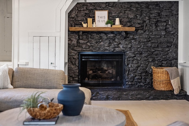 living room with a stone fireplace