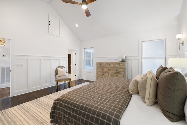 bedroom with dark hardwood / wood-style flooring, vaulted ceiling, and ceiling fan