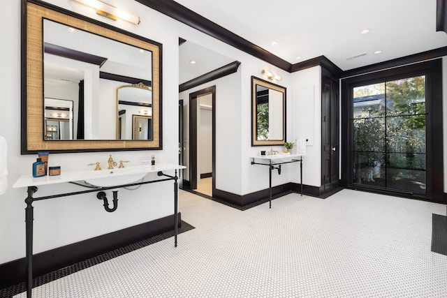 bathroom featuring crown molding and vanity