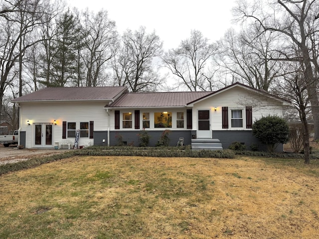 single story home featuring french doors and a front yard