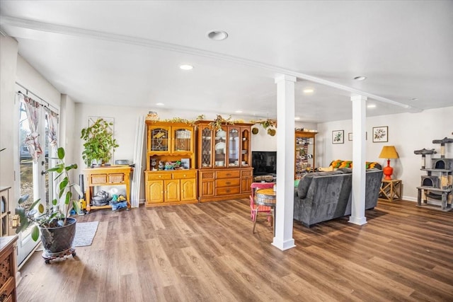 living room featuring hardwood / wood-style flooring and decorative columns