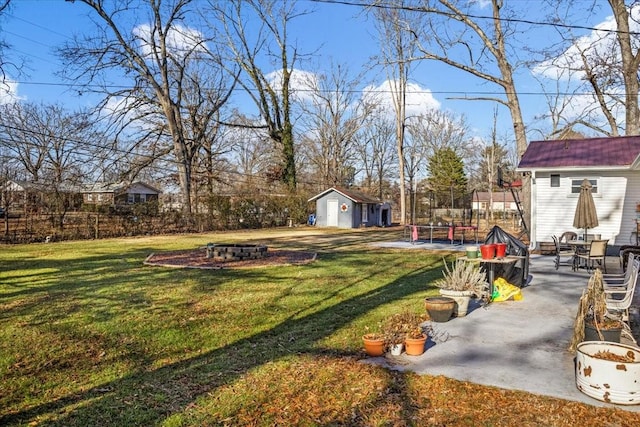 view of yard featuring an outdoor fire pit and an outdoor structure