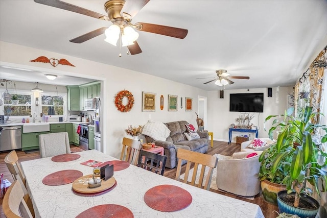 dining space featuring hardwood / wood-style flooring and sink