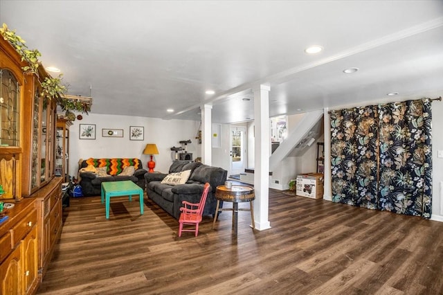 living room with ornate columns and dark wood-type flooring