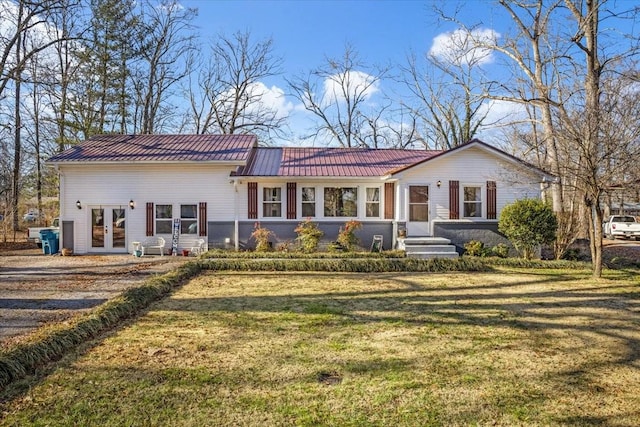 view of front of home featuring a front yard and french doors