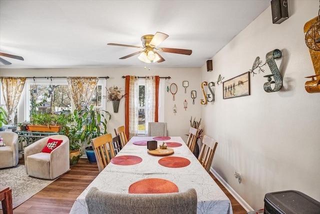 dining area with dark hardwood / wood-style flooring and ceiling fan