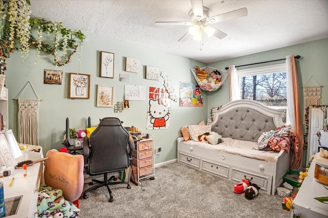 bedroom featuring ceiling fan, light colored carpet, and a textured ceiling