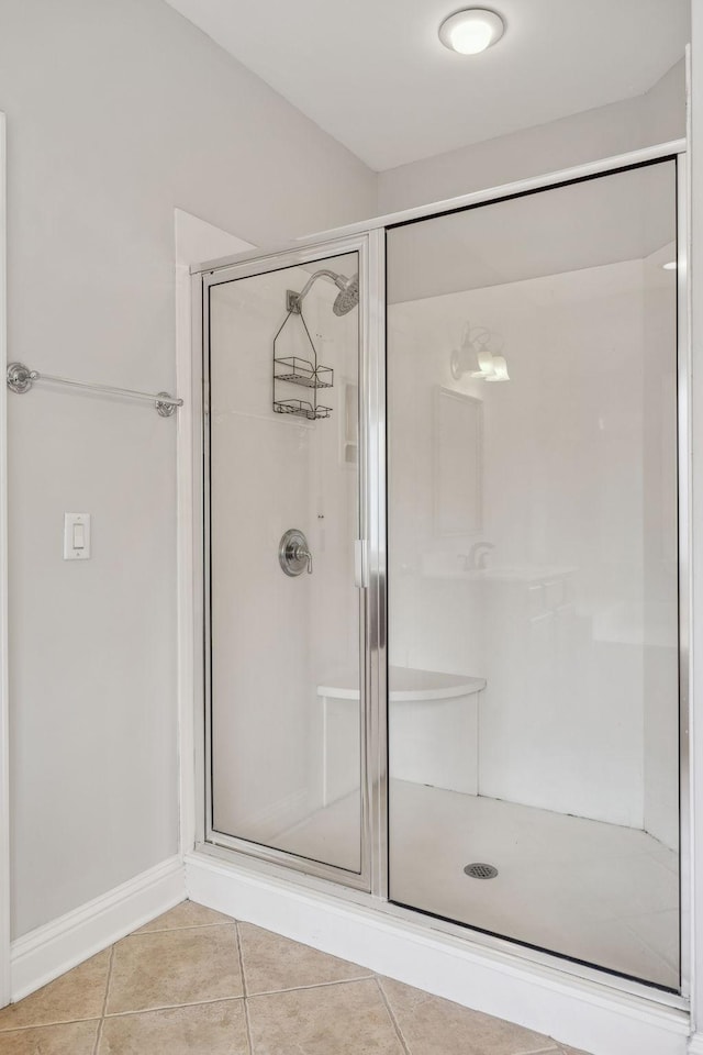 bathroom with tile patterned floors and an enclosed shower