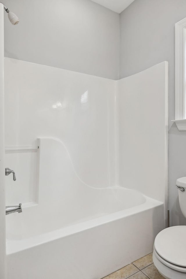 bathroom with toilet and tile patterned flooring