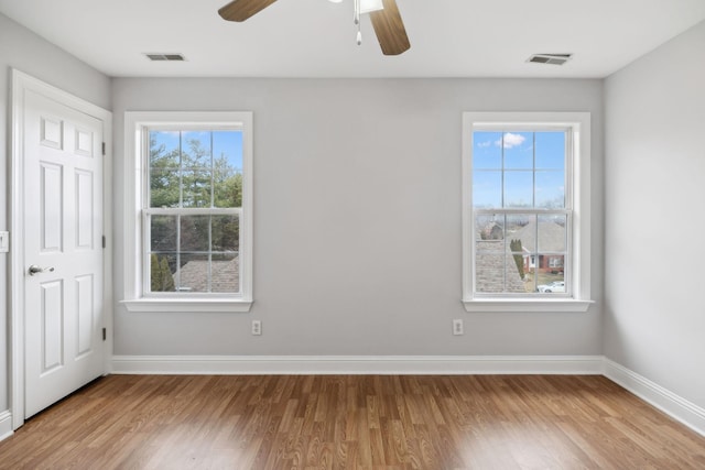 unfurnished room with hardwood / wood-style floors and ceiling fan