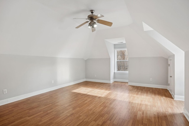 bonus room with lofted ceiling, ceiling fan, and light wood-type flooring