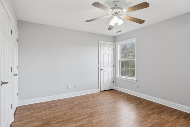 empty room featuring hardwood / wood-style floors and ceiling fan