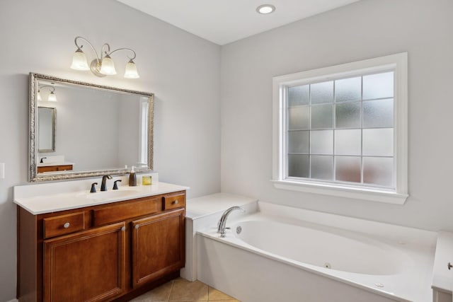 bathroom with vanity, a tub to relax in, tile patterned flooring, and plenty of natural light